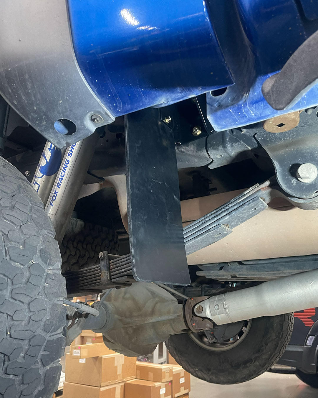 Ford Raptor frame-mounted rear shock guard protecting aftermarket suspension
