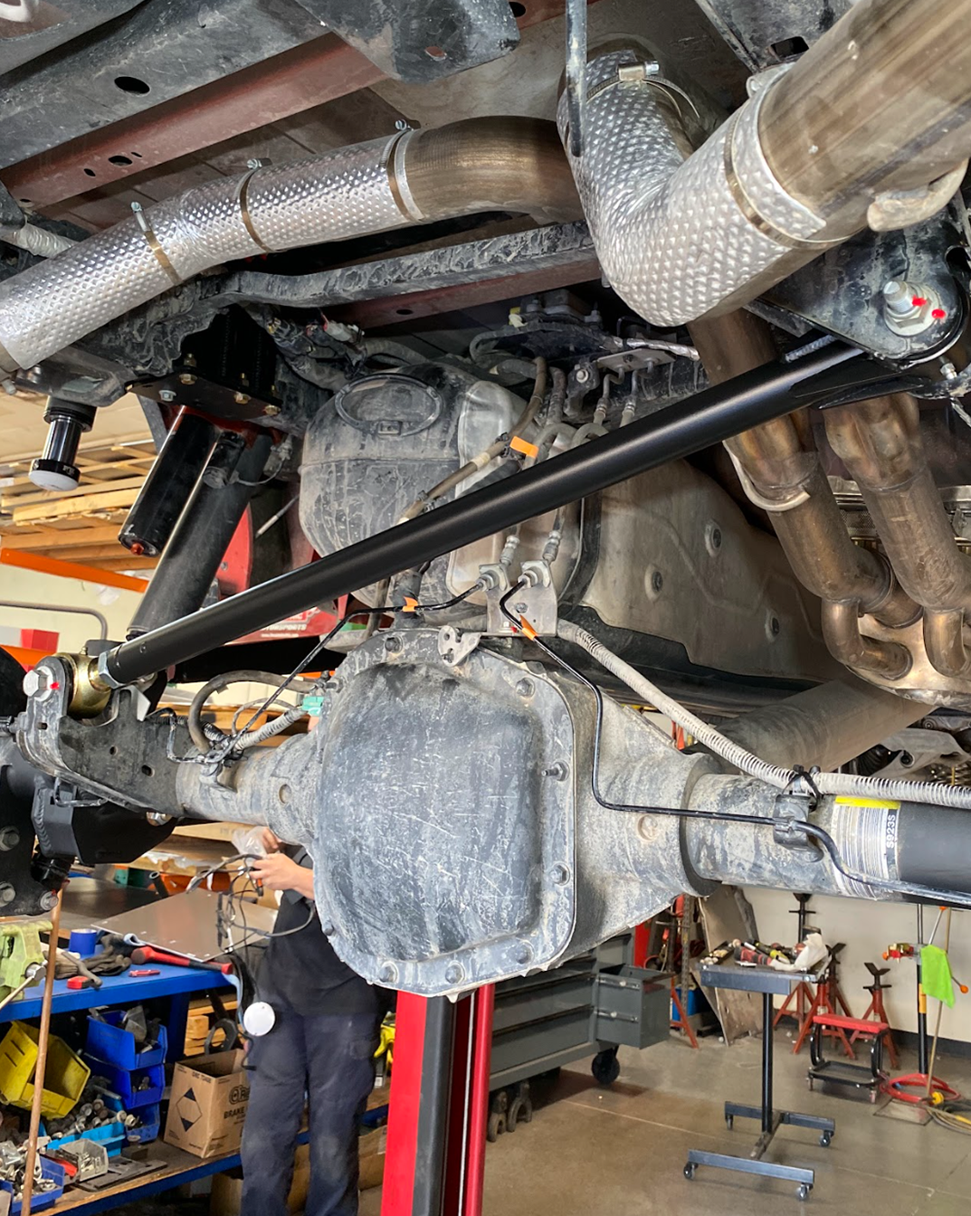 Adjustable panhard bar in place under a Raptor rear differential during installation at the Foutz Motorsports shop