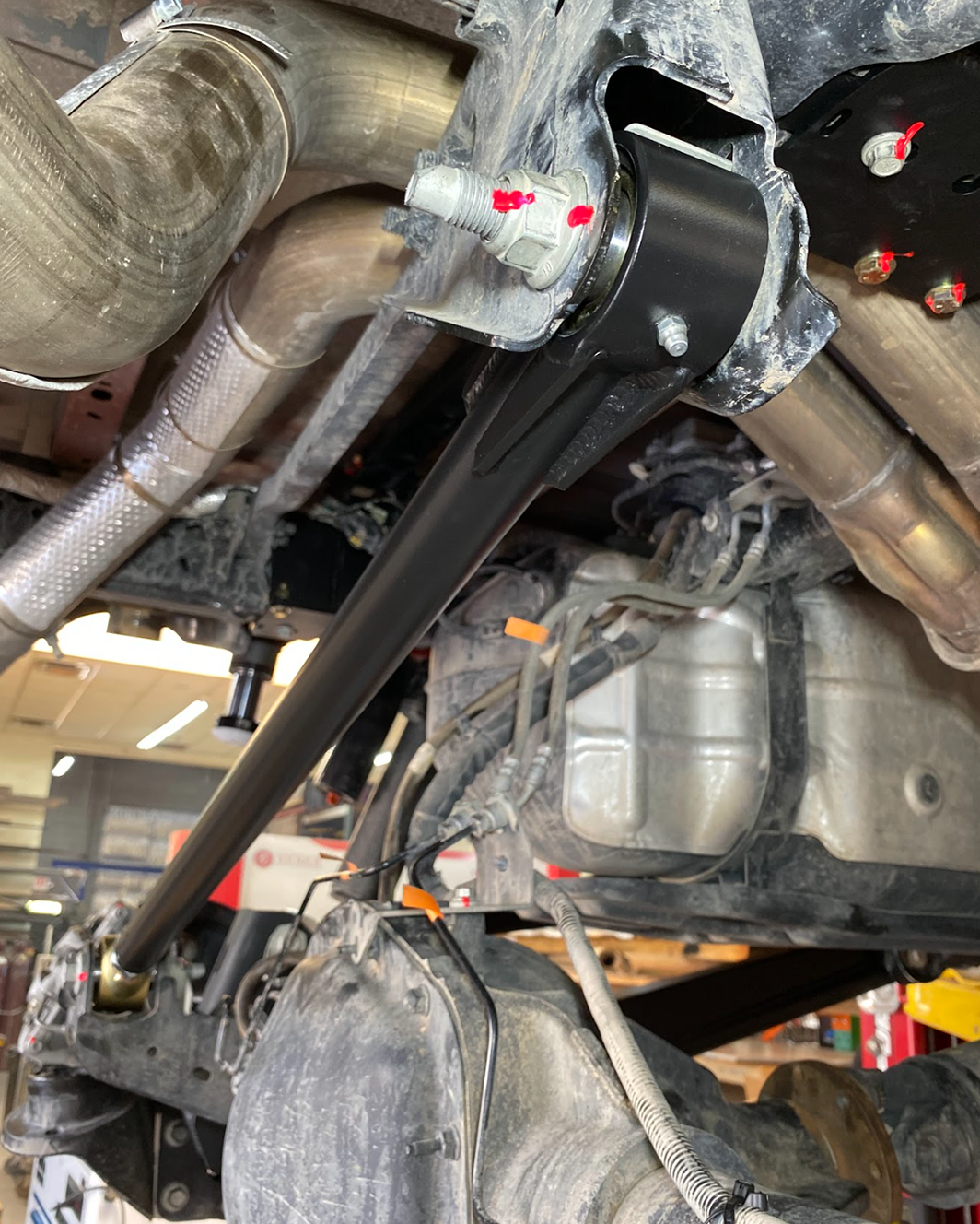 Axle side bracket of the Gen 3 Raptor panhard bar with the chromoly bar bolted through it