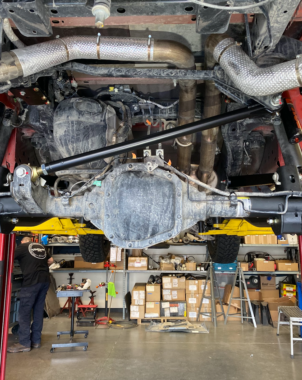 Rear underside of a Gen 3 Ford Raptor on the lift with the adjustable panhard bar spanning frame to axle