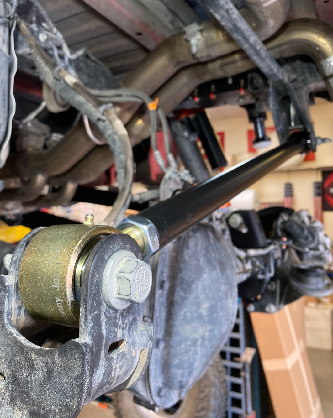 Close detail of the Johnny Joint at the frame side mount on a Gen 3 Raptor, urethane lined forged housing and retaining hardware