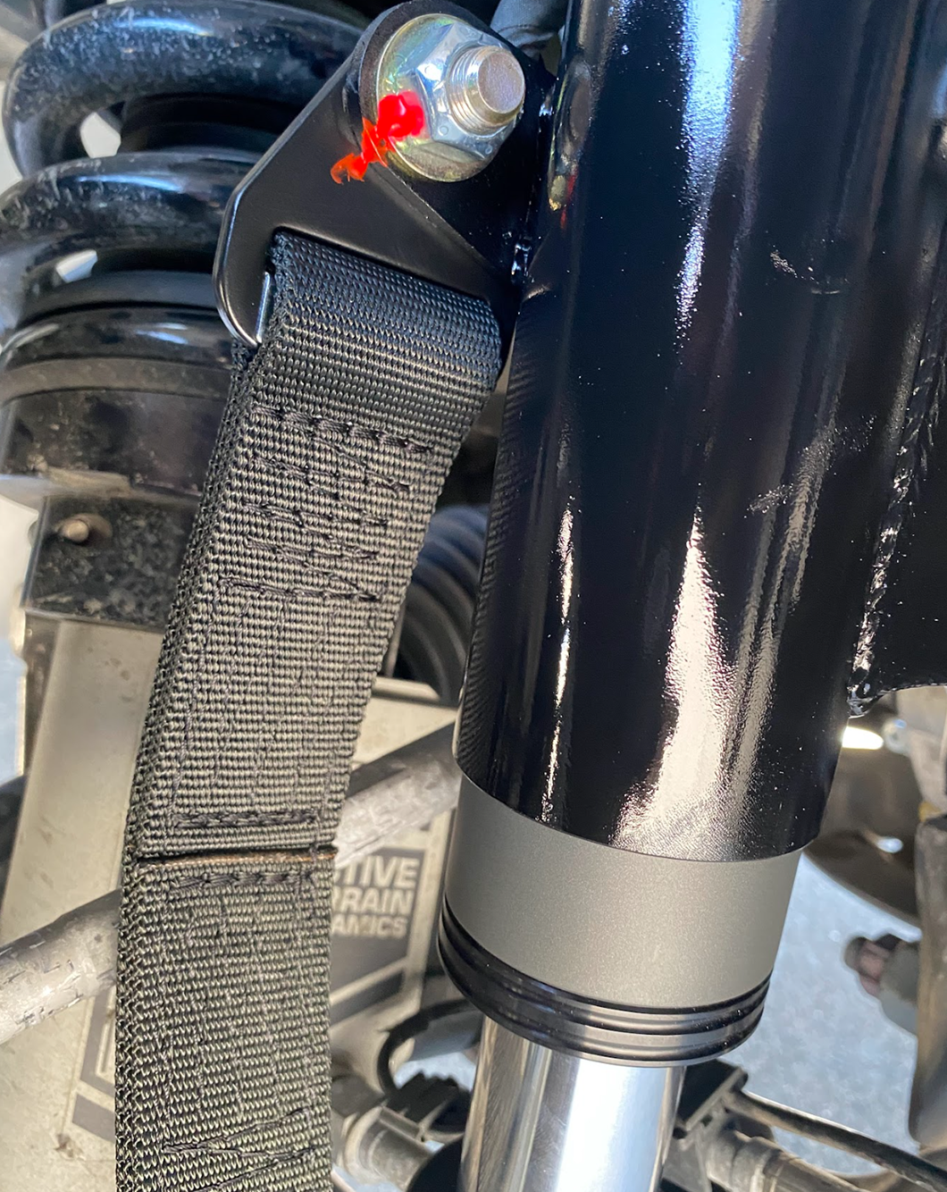 12 inch limit strap installed on a front bump stop for a ram TRX