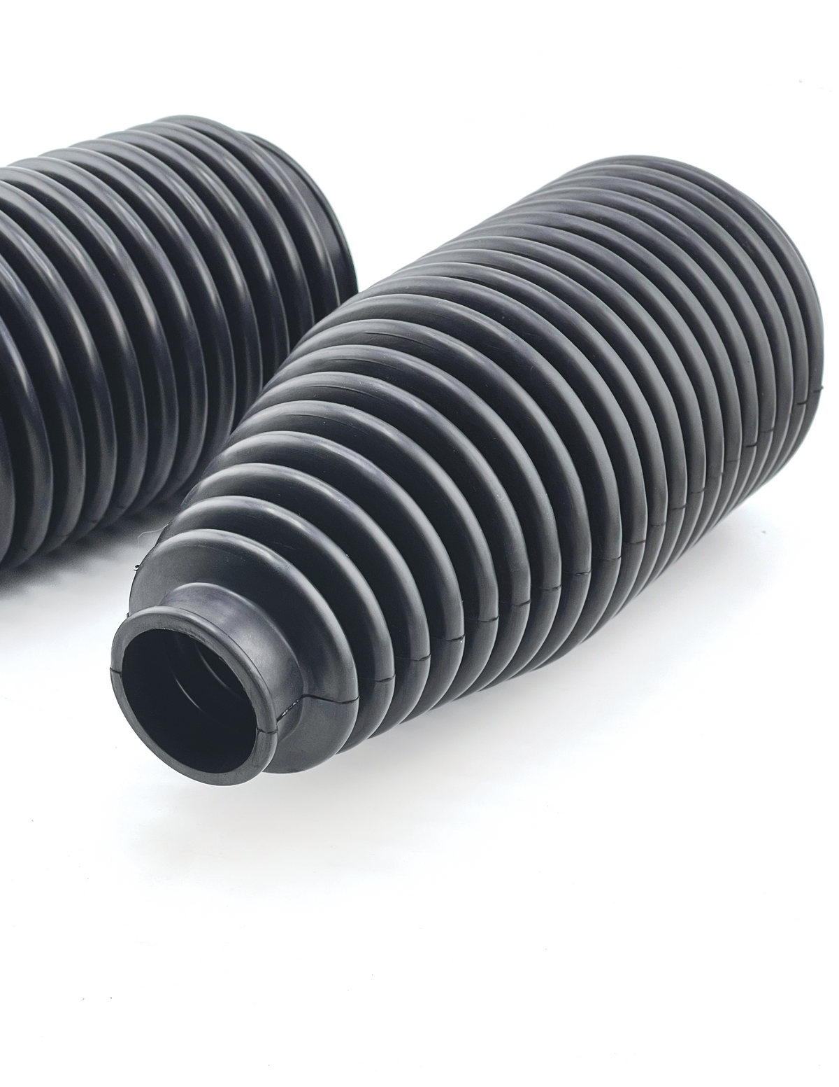 Close-up of ribbed urethane tie rod boot bellows that seal the steering rack on Foutz Motorsports billet tie rod kits