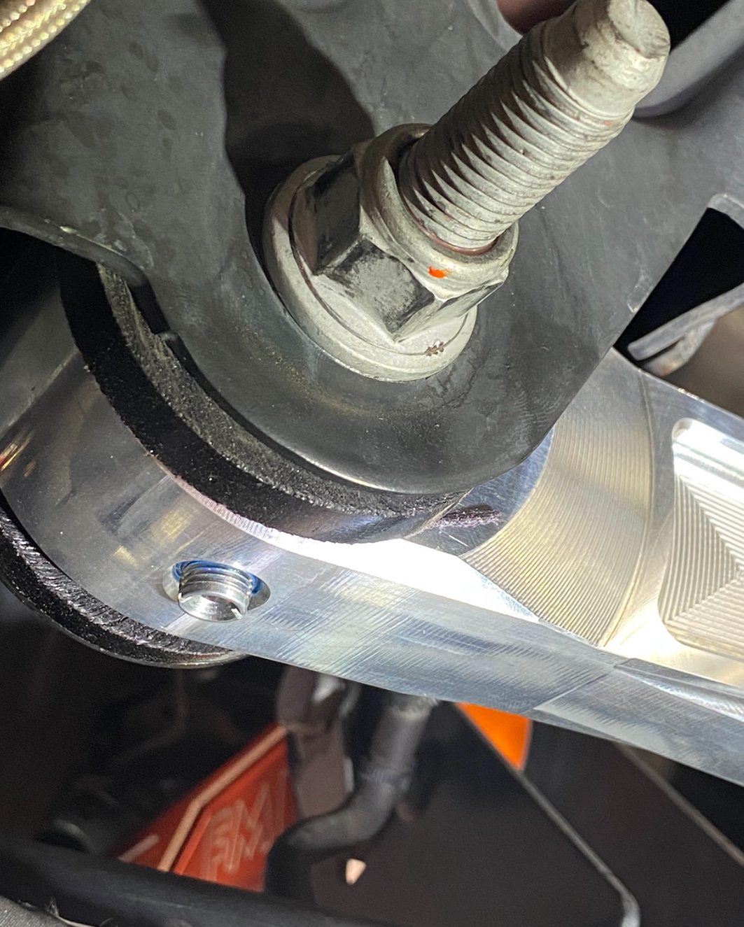 Raw billet panhard bar Ultra-Flex joint on the factory mount bolt, close detail