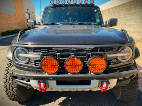 Bronco Raptor front bumper light mount brackets installed on stock modular bumper