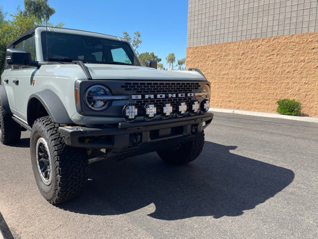 White Ford Bronco with a row of round LED light pods mounted on a Foutz Motorsports front light mount