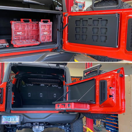 Ford Bronco with the rear hatch open showing a folding tailgate table and PACKOUT tool storage mounted inside