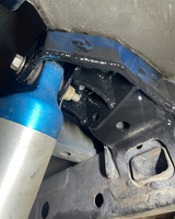 Gen 2 Raptor rear driver-side shock mount reinforcement installed with integrated limit strap mounting tab