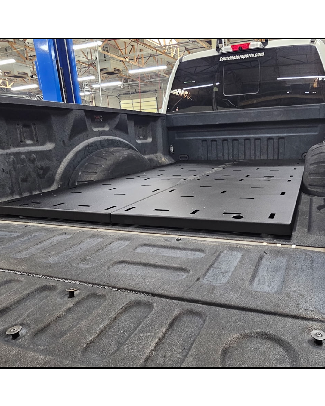 Side view of the Simple Bed Organizer deck plates running back to the tailgate of a Ford Super Duty