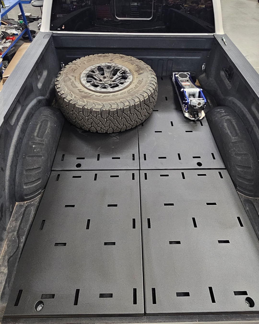 Ford Super Duty bed organizer complete kit carrying a spare tire and jack on the steel deck