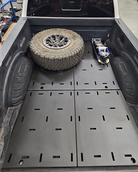 Ford Super Duty bed organizer complete kit carrying a spare tire and jack on the steel deck