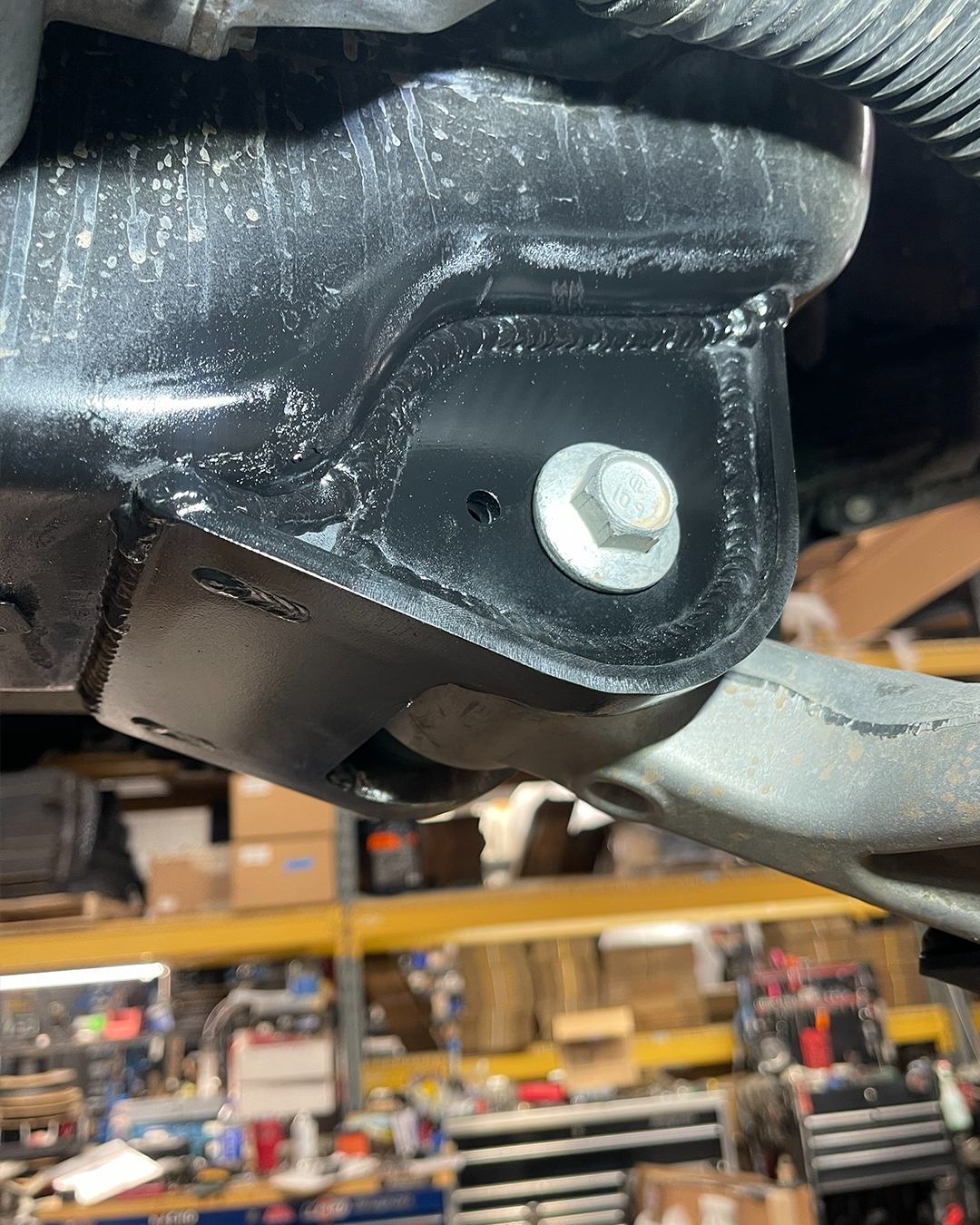 Weld-on low profile lower control arm pocket replacement improves Raptor ground clearance