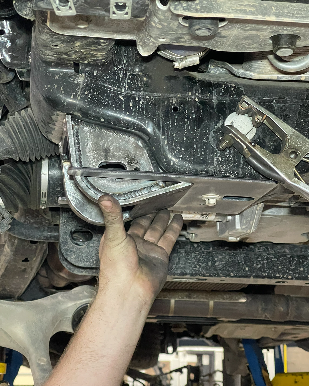 Low profile Raptor lower control arm pocket and alignment plate positioned for installation