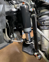 Close up of Stock lower arm Front Limit Strap with Bump Stop Stock for 2021-2024 Ram TRX suspension 