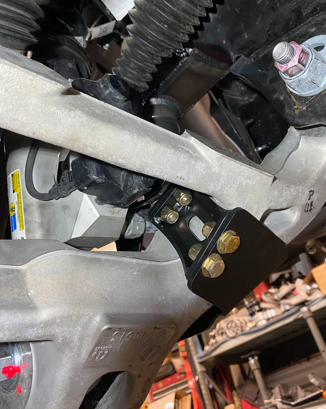 mounting  bracket close up a front limit strap with bump stop kit installed on a Ram RHO truck