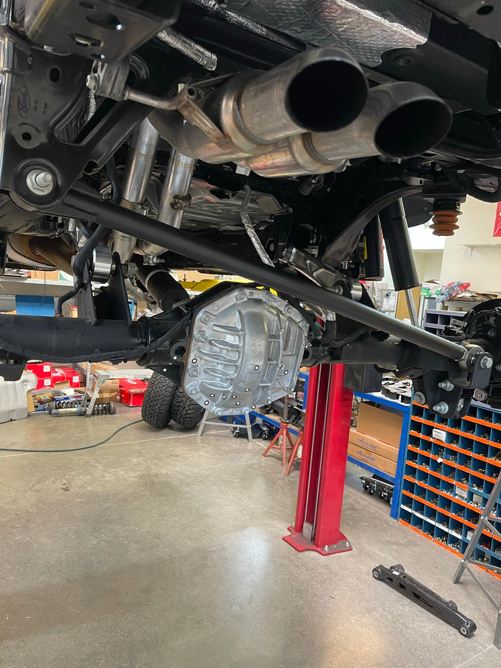 Underside view toward the rear axle of a Bronco Raptor fitted with raw billet rear arms
