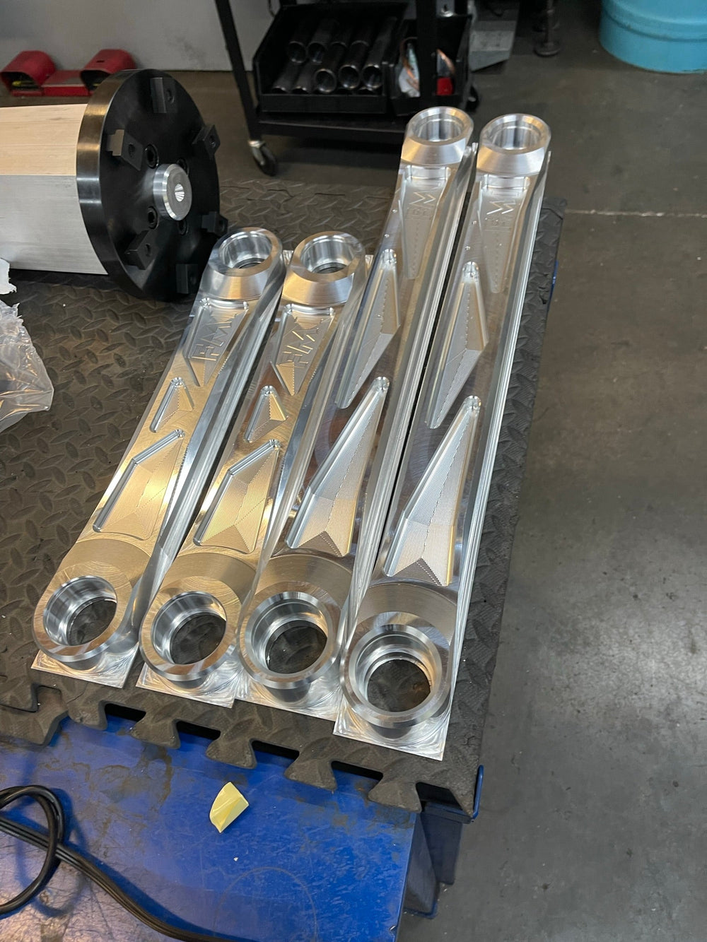 Complete set of four raw billet aluminum Bronco Raptor rear arms standing on end