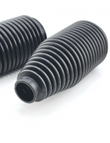 Close-up of ribbed urethane tie rod boot bellows that seal the steering rack on Foutz Motorsports billet tie rod kits