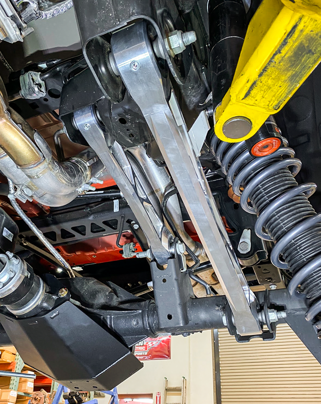 Raw billet rear link bolted to the Bronco Raptor rear axle bracket, viewed from the side