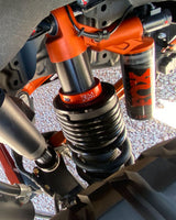 Bronco Raptor lift collars installed under factory coil spring