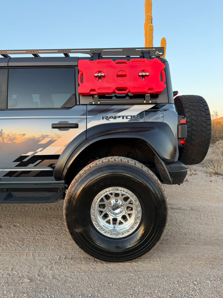 Ford Bronco Raptor rear quarter with roof rack and fuel cans, lifted on Geiser Off-Road progressive springs