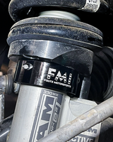Black anodized billet 2.5" leveling collar seated below the factory front coil spring perch on a 2027 Ram TRX
