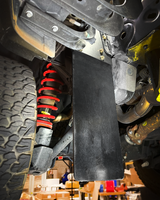 Rear shock protection mud flap installed on a 2024+ Ranger Raptor with exposed rear shocks