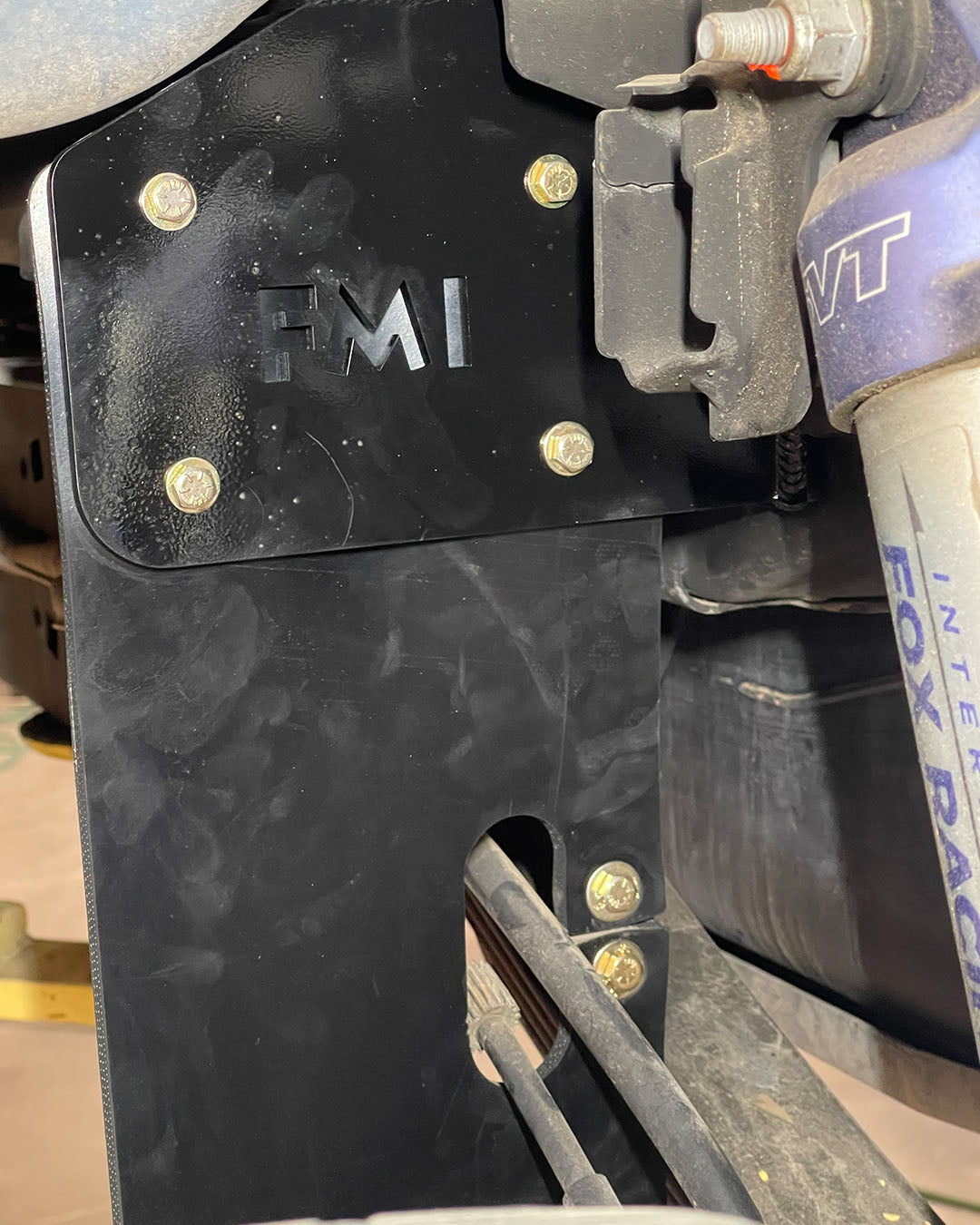 2010-2014 Raptor rear shock guard mud flap designed around factory e-brake cable routing