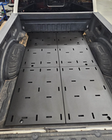 Full-length Super Duty bed deck showing the four bolt-together deck plates in textured Hammer Black powder coat
